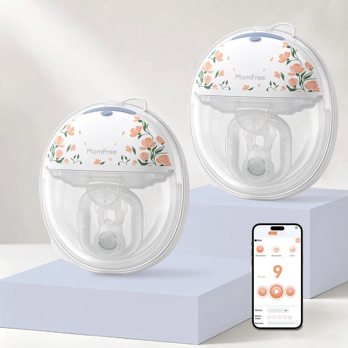 Two Momfree F6 Floral wearable breast pumps on lilac display blocks beside a phone showing the app.