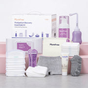 Momfree Ultra postpartum recovery kit with peri bottle, foam, cream, underwear, pads, socks, and bag arranged on a gray surface.