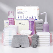 Momfree Ultra postpartum recovery kit on pink display blocks with underwear, pads, socks, peri bottle, foam, cream, and storage bag.
