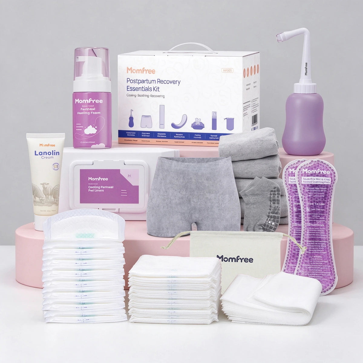 Momfree Ultra postpartum recovery kit with a retail box, peri bottle, foam, cream, underwear, pads, socks, and storage bag.